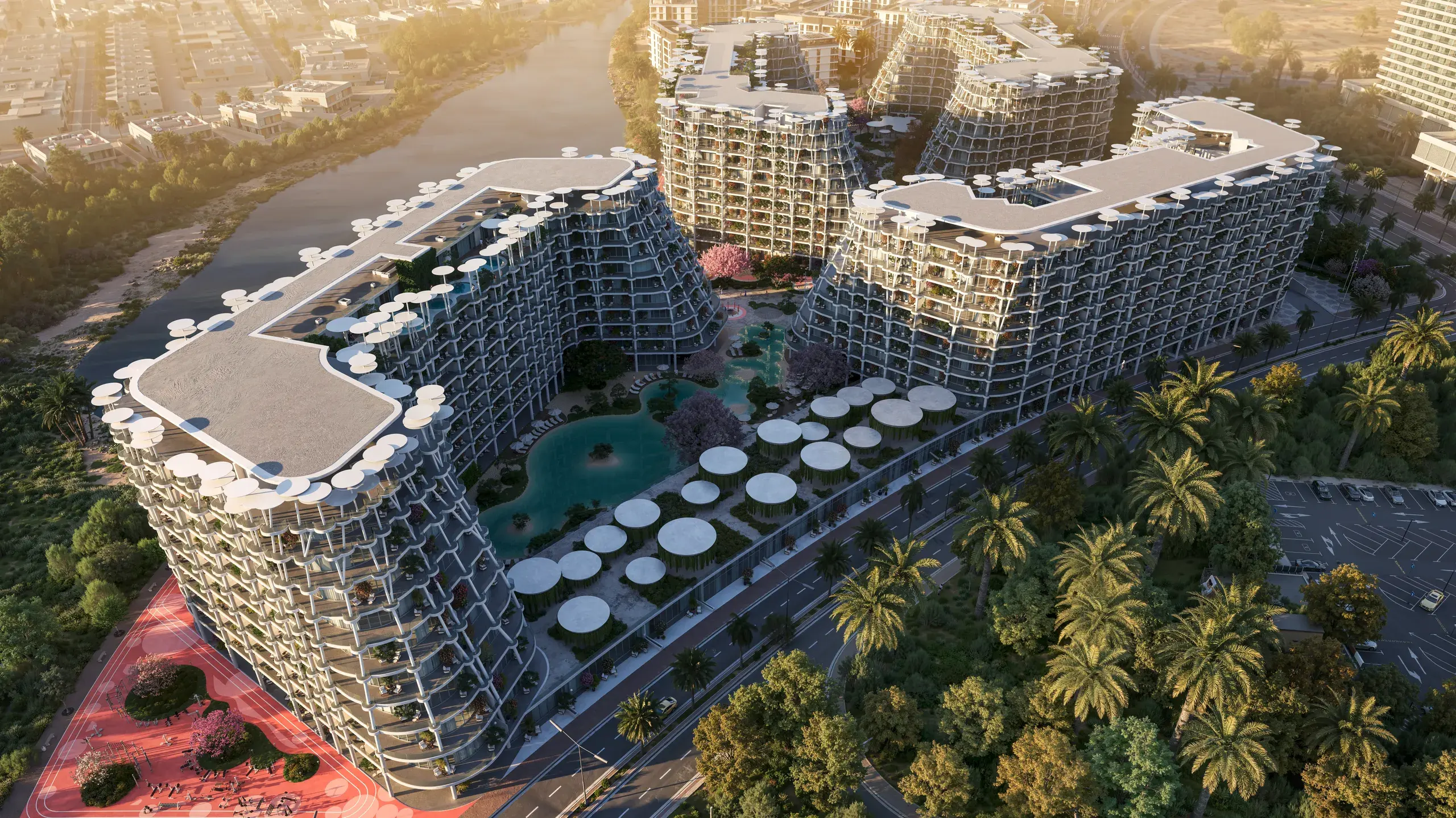 Sakura Gardens: aerial view of the corner tower, its pool and the parasols at golden hour