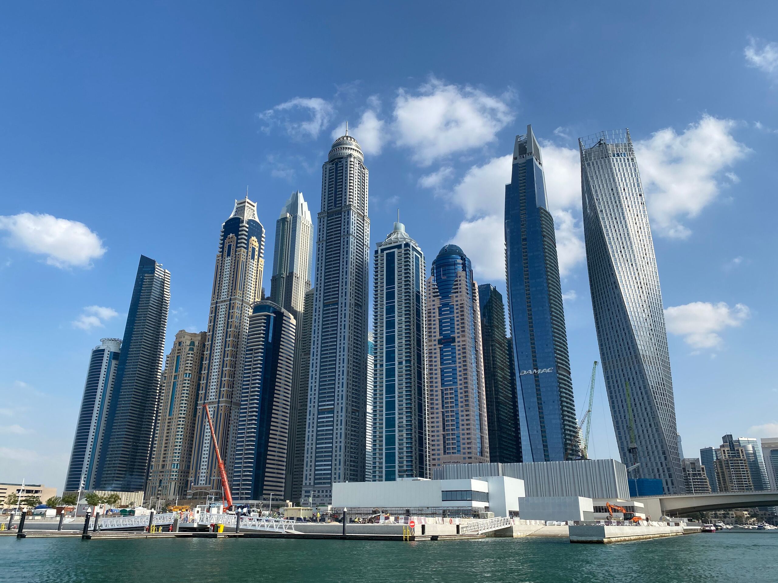 Dubai Marina towers under a blue sky